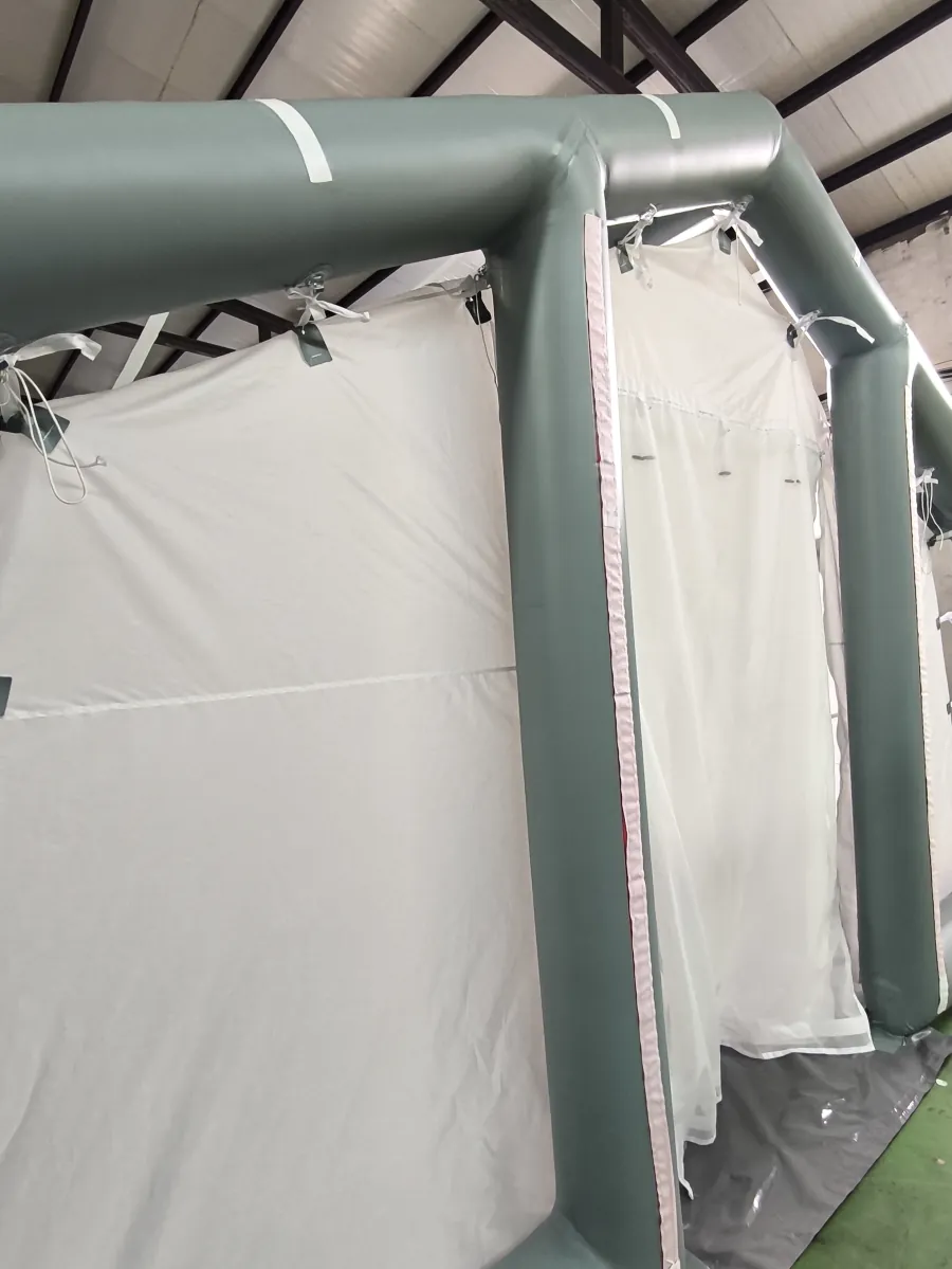 Close view of an inflated air beam and attached fabric wall panel during shelter assembly