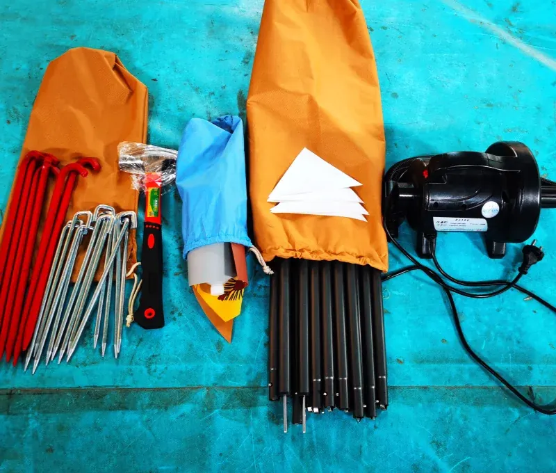 Orange carry bags, red and steel ground pegs, black poles and an electric pump laid out on a teal floor