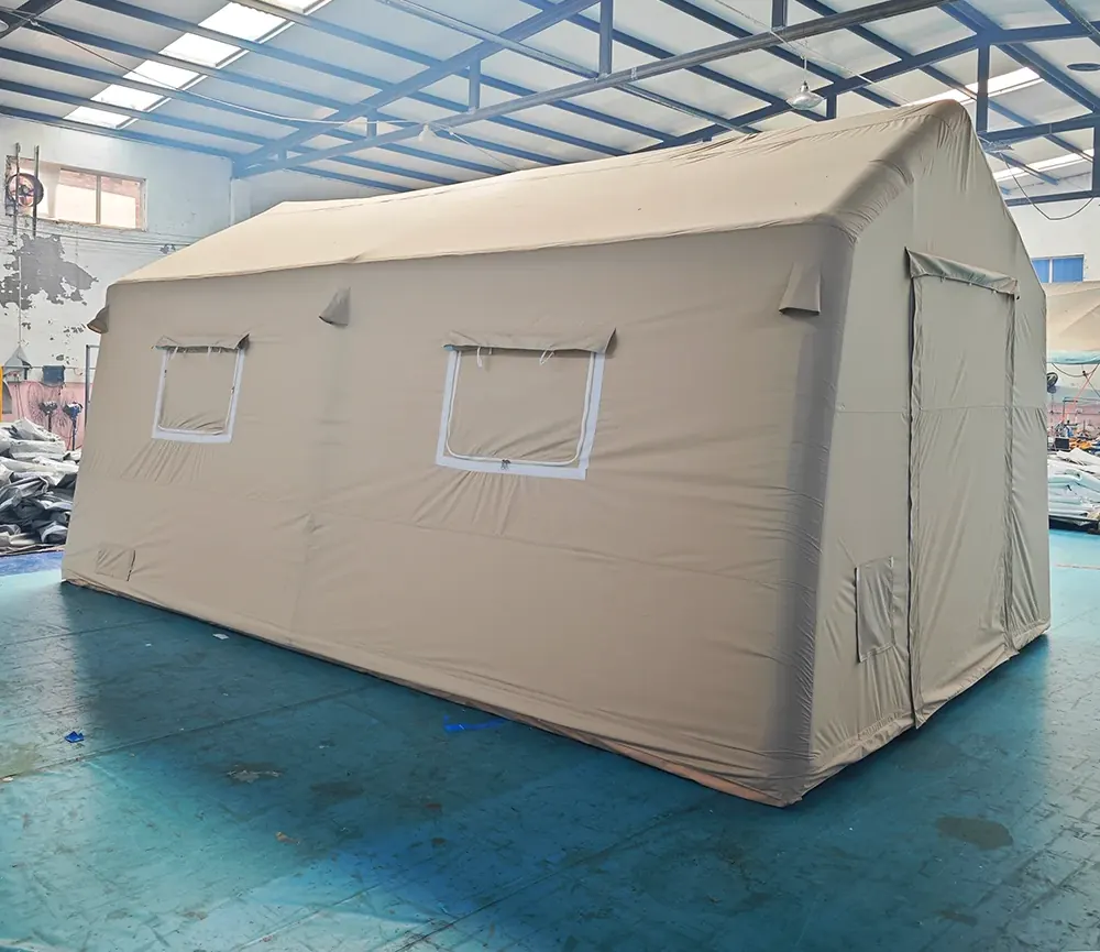 Beige inflatable shelter with a window flap and zipped door standing in a tent workshop
