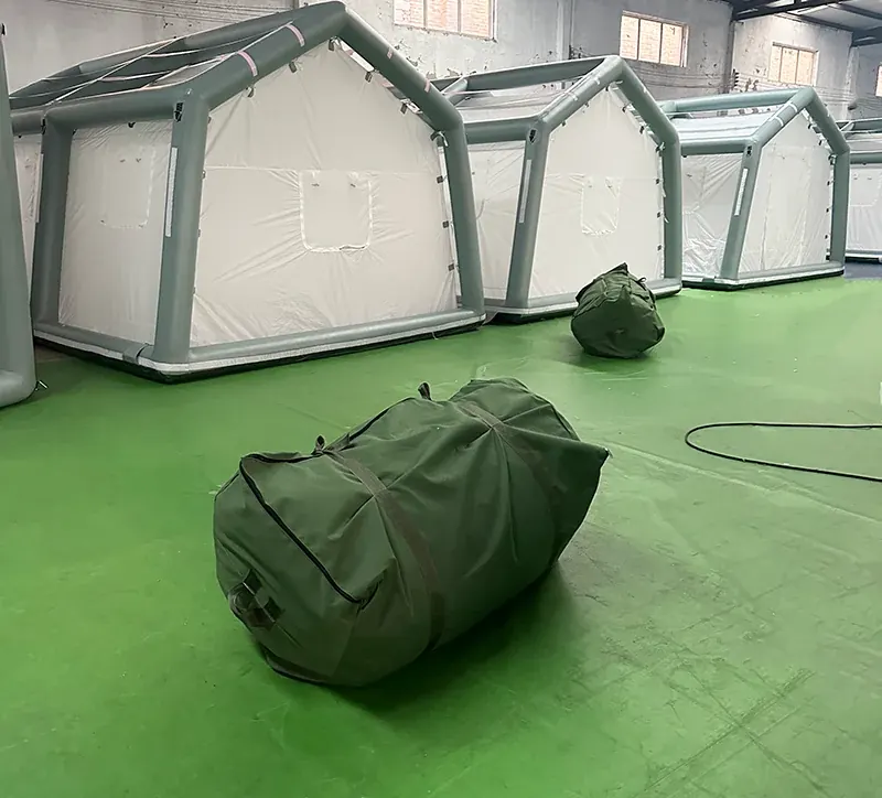 Row of white air-beam shelters with grey frame tubes standing in a workshop