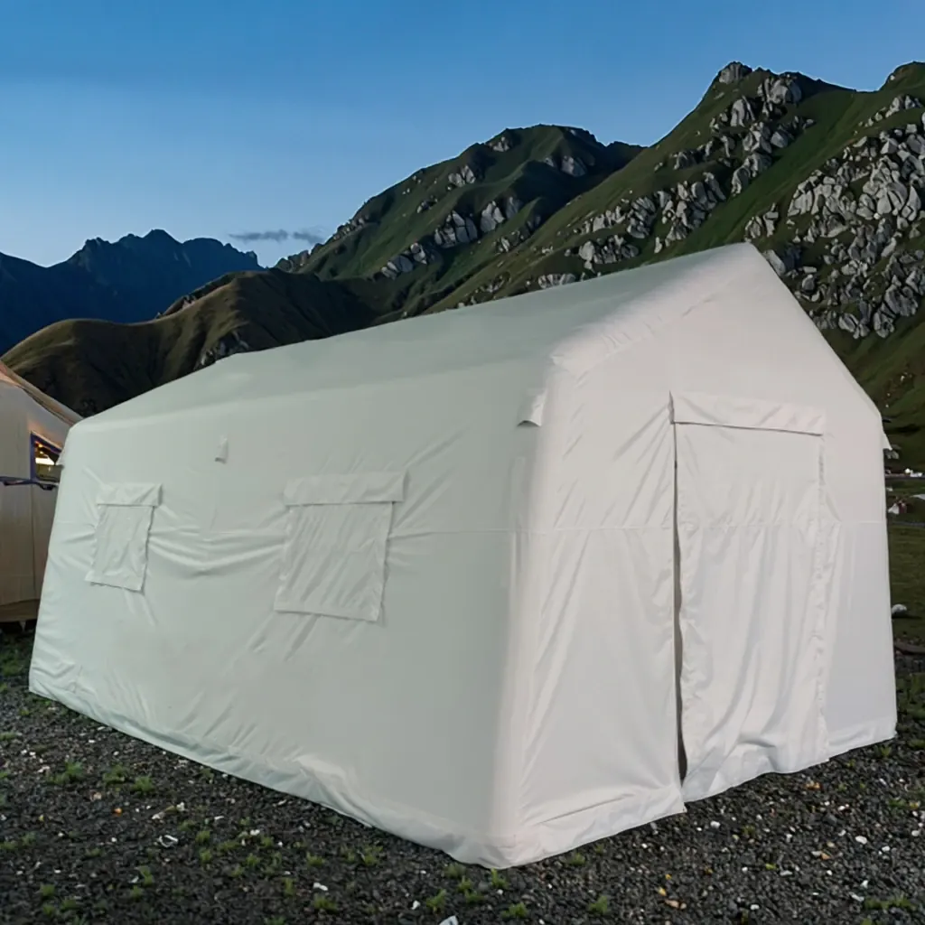 White inflatable shelter with two windows and a zipped door set up on gravel