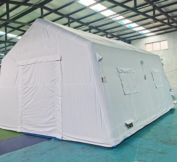 White inflatable shelter with side windows assembled on a workshop floor for inspection