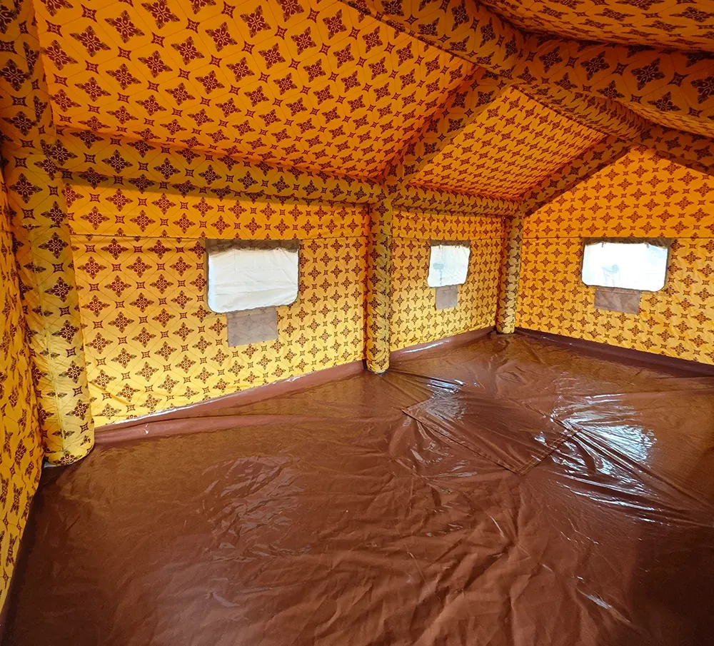 Interior of a shelter with a yellow and brown patterned lining, small windows and a brown floor