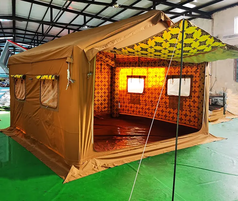 Tan inflatable shelter with yellow rolled door panels and a window under a steel workshop roof